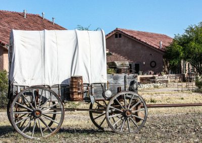 Antique Covered Wagon in front of ranch